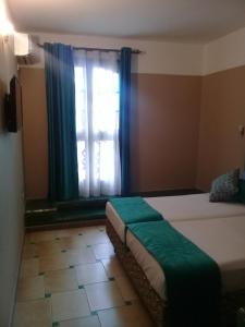 Postel nebo postele na pokoji v ubytování Hotel Batha
