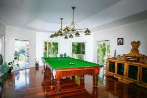 a living room with a pool table in it at Noosa hinterland Hidden valley retreat in Cooloolabin