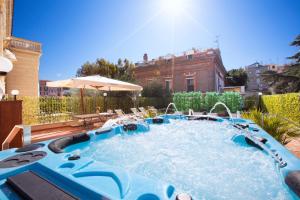 a pool in a yard with chairs and an umbrella at La Terrazza 38 in Sorrento