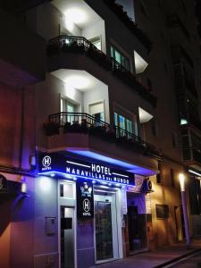 a hotel sign in front of a building at night at Hotel Maravillas del Mundo in Calpe
