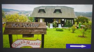 a small house with a sign in front of it at Holiday Home Vila Milka in Kremna