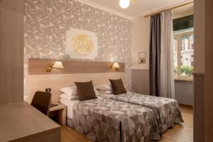 Ένα ή περισσότερα κρεβάτια σε δωμάτιο στο Hotel Dorica