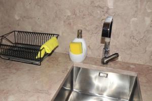 a kitchen counter with a sink and a soap dispenser at Casa Gil Vicente in Almada +92 photos