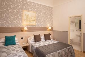 Ένα ή περισσότερα κρεβάτια σε δωμάτιο στο Hotel Dorica