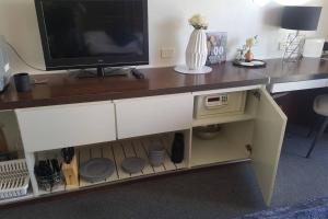 a desk with a television on top of it at Surfers Ocean View Sleeps 4, Free WIFI, Washing Machine, Large Fridge in Gold Coast