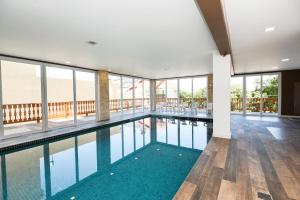 a swimming pool in a building with glass windows at Hotel Alles Berg in Nova Petrópolis