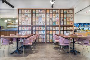a restaurant with wooden tables and purple chairs at Signature Ortahisar Hotel & SPA in Ürgüp