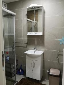 a bathroom with a sink and a mirror at Apartman Downtown in Vrnjačka Banja +11 photos