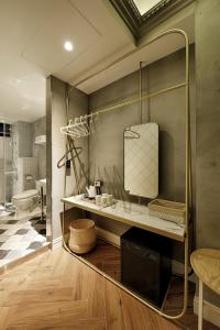 a bathroom with a sink and a toilet in a room at STABLE HOTEL in Anping