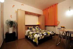 a bedroom with a bed and a window and a table at Bedrooms B&B in Pescara