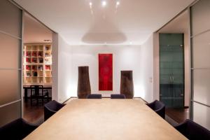 a conference room with a large table and chairs at MyTALE Apartment Luxury Torre Argentina in Rome