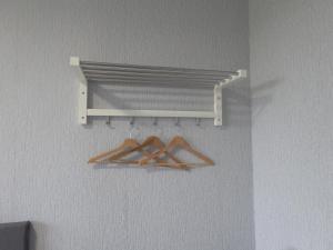 a shelf with three wooden hangers on a wall at Haven Inn in Barrow upon Humber