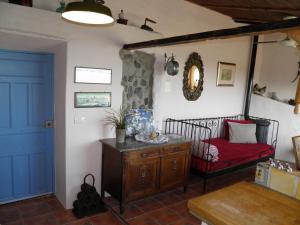 a bedroom with a bed and a blue door at Casa Coronela in Garachico