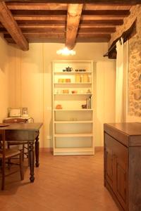 a dining room with a table and a refrigerator at B&B Cal Torello in Urbino