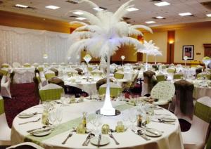 a large banquet room with white tables and chairs at Britannia Hotel Newcastle Airport in Newcastle upon Tyne