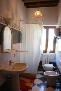 a bathroom with a sink and a toilet at Fattoria Le Chianacce in Cortona