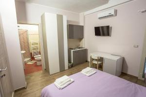 Postel nebo postele na pokoji v ubytování San Andreas Suites