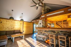 a living room with a couch and a stone fireplace at Siedlisko Zagórze in Nowa Huta