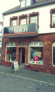 a store front of a brick building with a sign at Gästehaus Flair in Mettlach