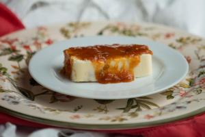 a piece of cake on a plate on a table at Pousada da Alcobaça in Itaipava