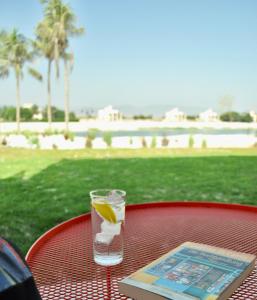 a drink on a table with a slice of lemon at Luxury Suite - Amazing Views & Lovely Garden in Salalah