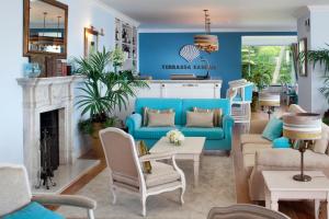 a living room with a blue couch and chairs at Senhora da Guia Cascais Boutique Hotel in Cascais