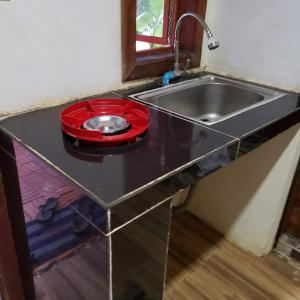 a kitchen counter with a sink and a red bowl at Yi family Homestay in Siem Reap +225 photos