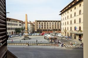 a group of people walking around a street in a city at Casa Cosi - Maria Novella in Florence