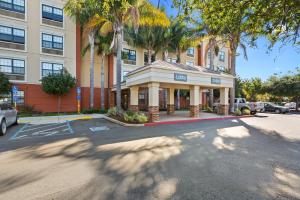 a building on a street in front of a parking lot at Extended Stay America Premier Suites - Union City - Dyer St in Union City