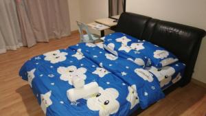 a bed with a blue comforter with sheep on it at Polo Park Resort Condominium in Johor Bahru