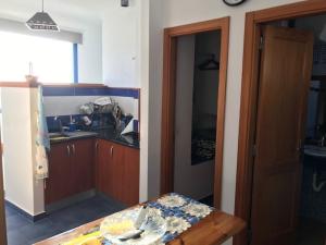 a kitchen with a table and a counter top at CasaPello TOP TERRACE in Puerto de las Nieves