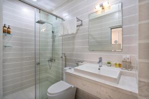 a bathroom with a toilet and a sink and a shower at ViVo 416 Apartment in Ho Chi Minh City +39 photos