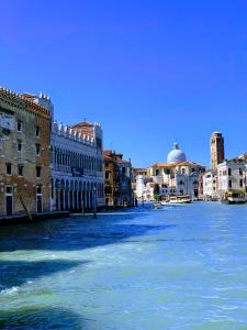 a view of a river in a city with buildings at Rialto Mercato apartment suite in Venice