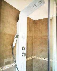 a shower with a shower head in a bathroom at Amariglio Apartment in Sassari