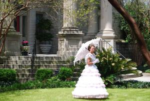 a woman in a wedding dress holding an umbrella at Graystone Inn in Wilmington
