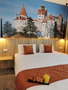 a bedroom with two beds with a castle in the background at YMY Boutique Residence in Bucharest +108 photos