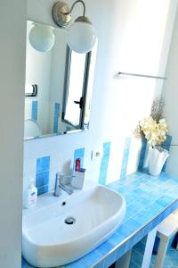 a bathroom with a sink and a mirror at VillaColì Menfi in Menfi