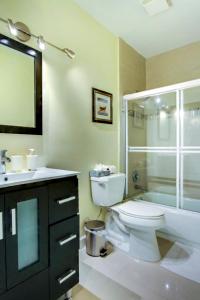 a bathroom with a toilet and a sink and a shower at Castle Ph3 in Miami Beach