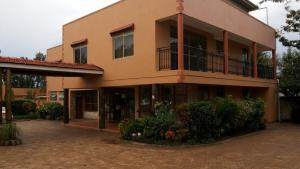 a building with a balcony on the side of it at MakanHill Resort Hotel in Mityana