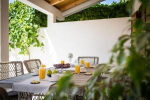 a table with food and orange juice on it at Holiday Home Floreat in Orebić