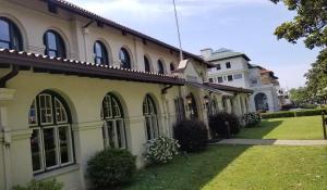 a large building with a grass yard in front of it at Hotel Hale in Hot Springs