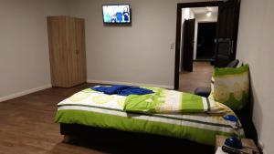a bedroom with a bed and a tv on the wall at Monteurwohnung in Zerbst