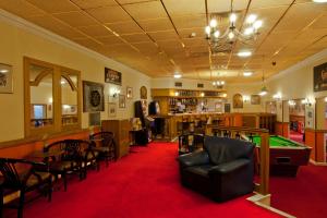 a billiard room with a pool table and a bar at Britannia Hotel Wigan in Standish