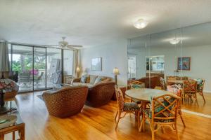 a living room with a table and chairs and a couch at Country Club Villas in Kailua-Kona