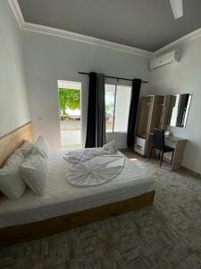 a bedroom with a large bed and a desk at String Wave Maldives in Gulhi
