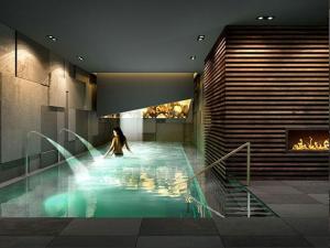 a woman in a swimming pool in a building at Chalet Residences Mathon in Ischgl