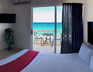 a bedroom with a bed and a view of the ocean at Cancún Plaza Sea View in Cancún