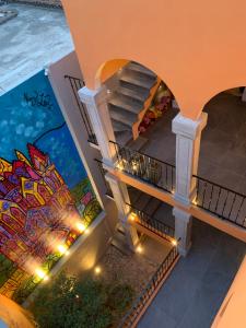 a staircase in a building with a mural at El Secreto in San Miguel de Allende