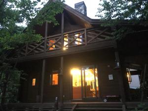 a house with a front porch with the door open at Log sweet Villa YU.CABIN / Vacation STAY 5351 in Inawashiro