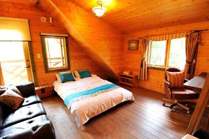 a bedroom with a bed in a log cabin at Log sweet Villa YU.CABIN / Vacation STAY 5351 in Inawashiro
